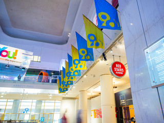 View of the balcony hosting YOU! The Experience displaying blue and yellow flags celebrating the Museum's 90th anniversary.