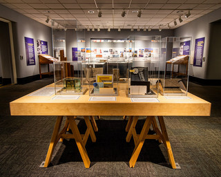 A wooden table display with many different architectural artifacts